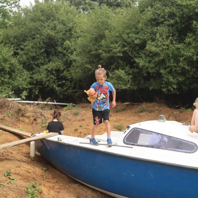 Children enjoying outdoor play on a boat at Playful Paths, promoting adventure and imaginative outdoor activities.